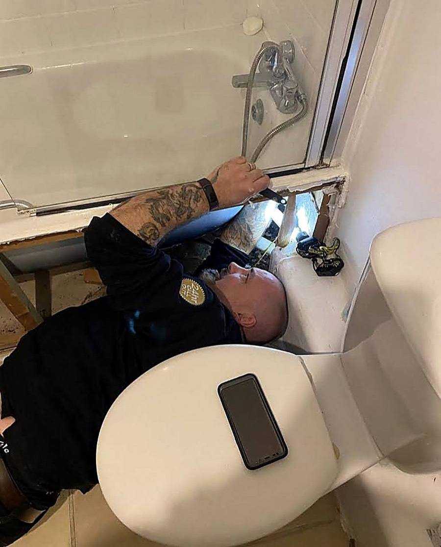 Neos Engineering engineer working on bath taps in a London bathroom